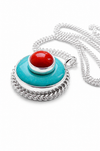 A silver pendant necklace featuring a round turquoise blue turquoise disc with a braided silver border, topped with a smaller silver ring holding a red coral cabochon stone, shown on a white background.